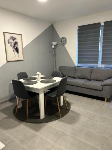 a living room with a table and chairs and a couch at Apartmani "Stari Grad - Samobor" in Samobor