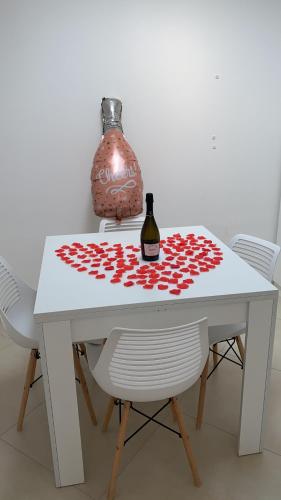 a white table with a bottle of wine on it at Marina Grande Holiday Apartment in Capri in Capri