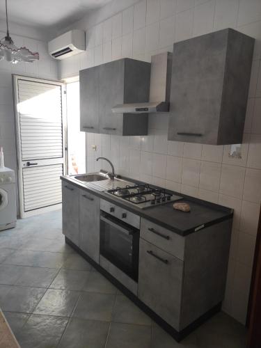a kitchen with a sink and a stove top oven at Un mare da sogno in Sannicola