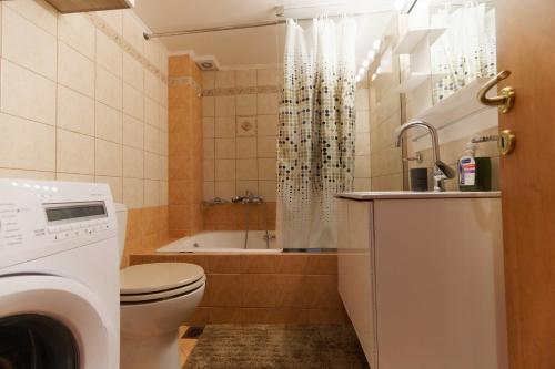 Cozy & Relaxing Apartments-Agia Paraskevi في أثينا: حمام مع مرحاض وحوض استحمام