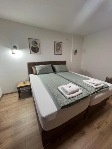 a bedroom with a bed with two towels on it at Apartman Antonovic in Valjevo