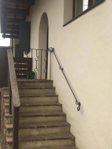 a set of stairs with a metal rail next to a building at Apartment Maximilian in Fiè