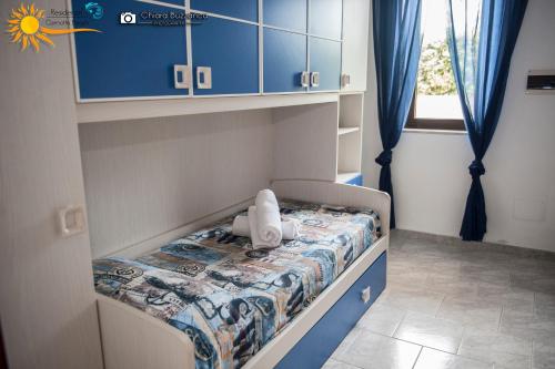 a small bed with a teddy bear sitting on it at Cannotta Beach - Salina in Terme Vigliatore