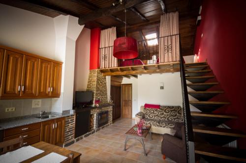 a living room with a spiral staircase in a house at Apartamentos El Sualleiro in Santa Eulalia de Oscos
