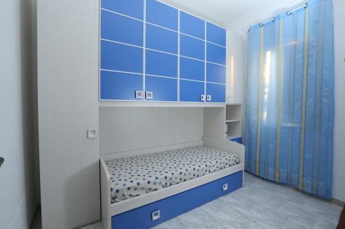 a small room with blue and white walls and a bench at Cannotta Beach - Alicudi in Terme Vigliatore
