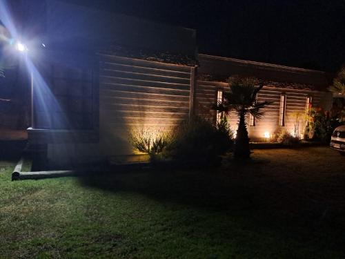 a house with lights on the side of it at night at Casa Lago Rapel, Las Cabras in Las Balsas