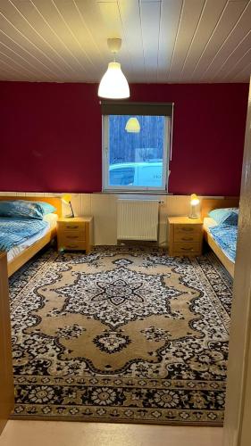 a bedroom with two beds and a large rug at Monteure, ganzes Haus, Schwarzheide, Haus 1 in Schwarzheide