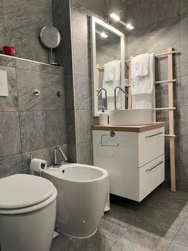 a bathroom with a toilet and a sink and a mirror at Renovated Apartment 5 min to Crans Montana Center in Crans-Montana