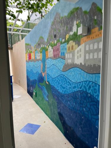 a mural of a city on a wall at Marina Grande Holiday Apartment in Capri in Capri