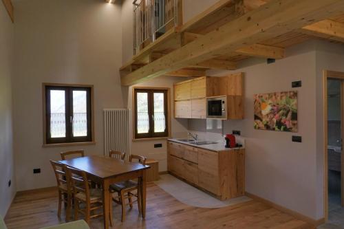 a kitchen and dining room with a wooden table at Albergo Diffuso Ceaglio Valle Maira in Marmora