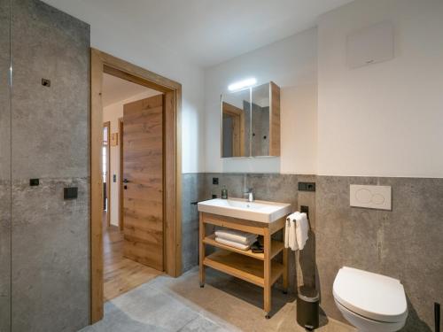 a bathroom with a sink and a toilet at Alpenliebe Zillertal in Hart im Zillertal