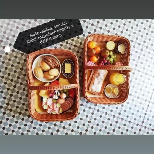 two baskets filled with different types of food on a table at Domeček u Josefa in Mělník