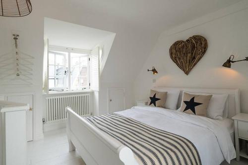 a white bedroom with a bed with stars on it at Fisherman's Cottage, Whitstable in Whitstable