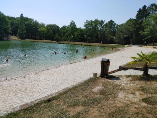 a group of people in the water at a beach at Nogapatio - Maison d'Hôtes - BnB in Nogaro