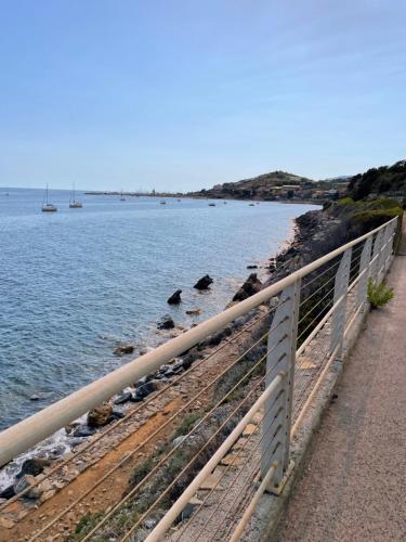 a bridge over a body of water next to a beach at Bistrot del mare in Santo Stefano al Mare