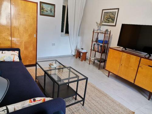 a living room with a couch and a tv at House Marineta - Makarska promenade in Makarska