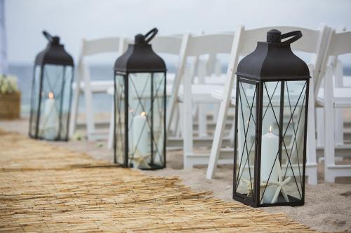 a row of lanterns on a beach with chairs at B Ocean Resort Fort Lauderdale Beach in Fort Lauderdale
