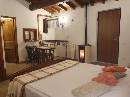 a bedroom with a bed and a table with a stove at Il Castelletto di Gomo in Godiasco