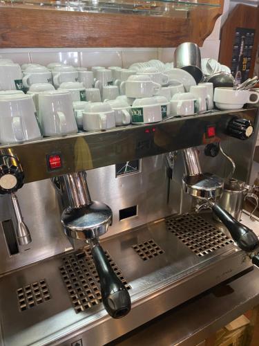 a coffee making machine with cups and dishes on it at Valhalla Panorama in Funchal