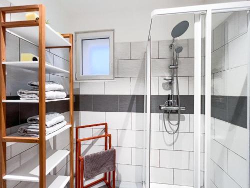 a bathroom with a shower and a glass shower stall at La coulée verte in Auxerre