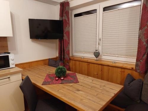 a wooden table with a plant on top of it at Apart Jakob in Schwendau