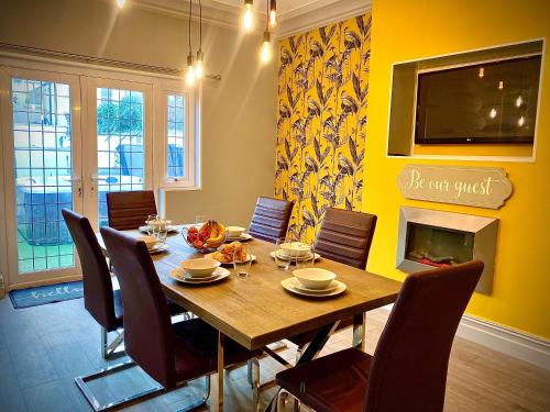 a dining room with a wooden table and chairs at Captivating 4-Bed Hot Tub House in Blackpool in Blackpool