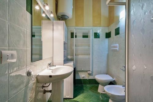 a bathroom with a sink and a toilet at Residenza_Golf_Club in Polpenazze del Garda