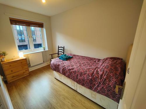 a bedroom with a bed and a dresser and a window at Great place in Newcastle in Newcastle upon Tyne