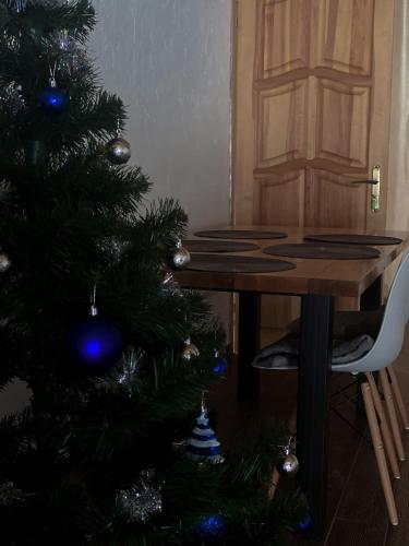 a christmas tree in a room with a table at Hillside in Slavske