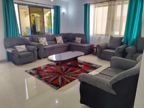 a living room with couches and a coffee table at 6 Park Retreat in Mombasa
