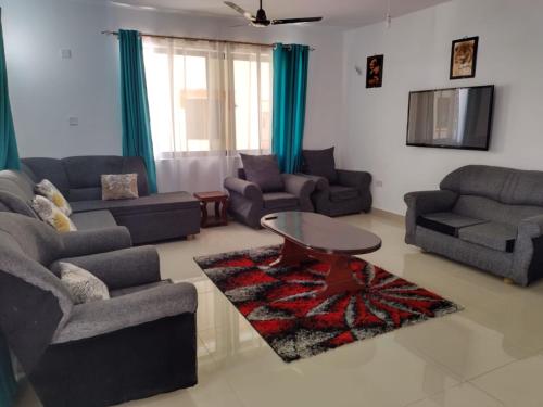 a living room with two couches and a coffee table at 6 Park Retreat in Mombasa