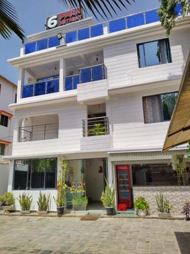 a white building with a sign on the front of it at 6 Park Retreat in Mombasa