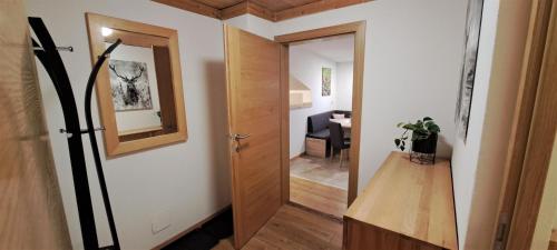 a hallway with a door leading to a living room at Unterlettlhof in Saalfelden am Steinernen Meer