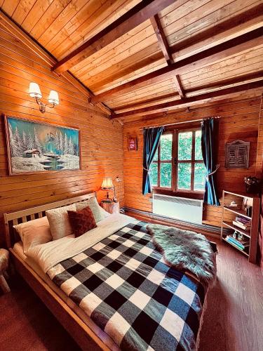 a bedroom with a large bed in a cabin at Montebello Chalet in Porumbacu de Sus