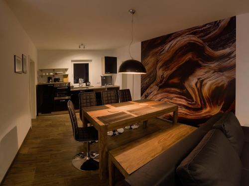 a living room with a table and a couch at Charming Apartments am See in Bad Saarow