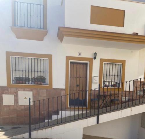 a building with two doors and a balcony at Casa Ana in Benaoján