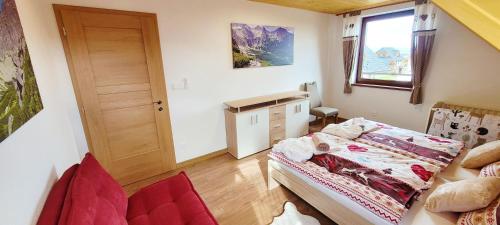 a small room with a bed and a window at chalupa Český štít Vysoké Tatry in Stará Lesná
