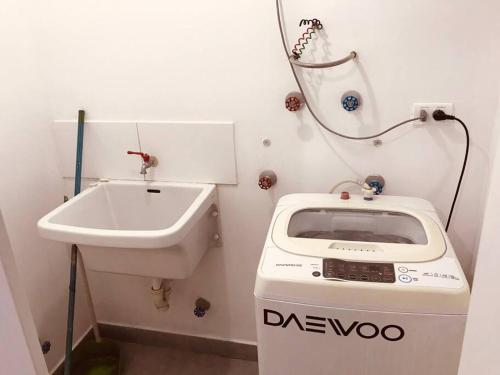een badkamer met een wastafel en een wasmachine bij Hermoso Departamento a media Cuadra de la Av Javier Prado in Lima