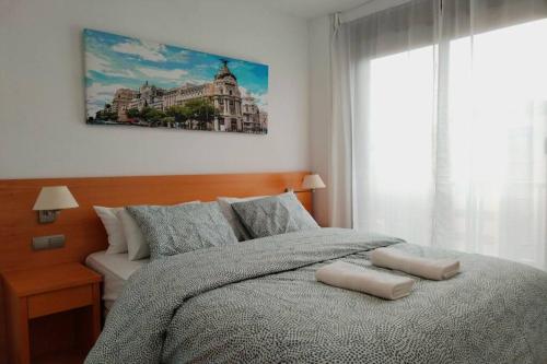 a bedroom with a bed and a large window at Aeropuerto Ifema Wanda CR in Madrid