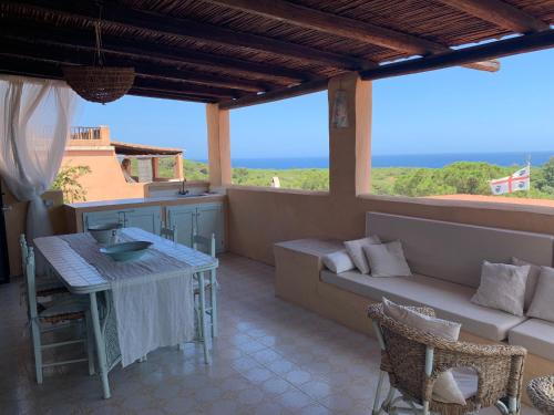a living room with a couch and a table at La Terrazza sul Mare in Fort Village