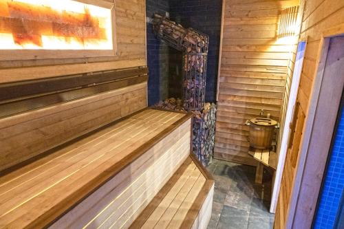 a wooden sauna with a toilet in a room at Готельно-банний комплекс Otelnov in Poltava