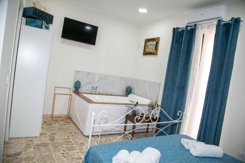a bedroom with a bed and a sink and a mirror at I MORI in Santa Teresa di Riva