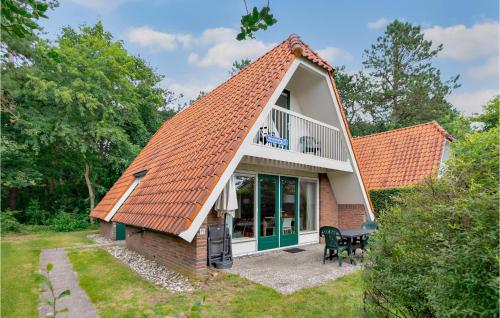 a small house with an orange roof at Awesome Home In Vlagtwedde With Kitchen in Vlagtwedde
