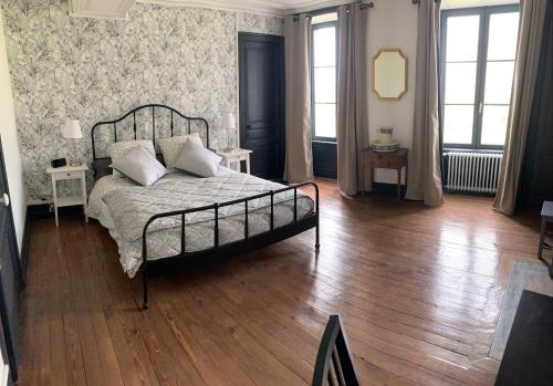 a bedroom with a bed and a wooden floor at CHÂTEAU DE FRANQUETOT & D Day Collins Museum in Sainte-Mère-Église