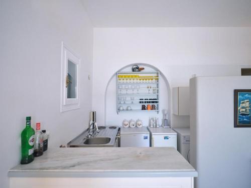 a white kitchen with a sink and a refrigerator at VILLA ALEXANDROS in Naousa