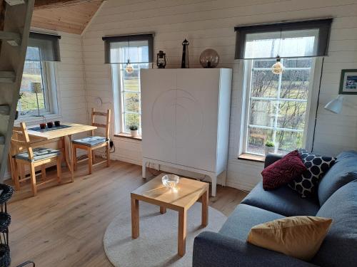 a living room with a couch and a table at Fully equipped cottage near the sea in Rockneby