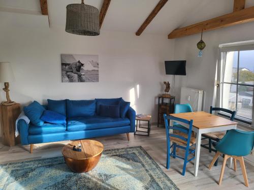 a living room with a blue couch and a table at Crampas 2 in Sassnitz