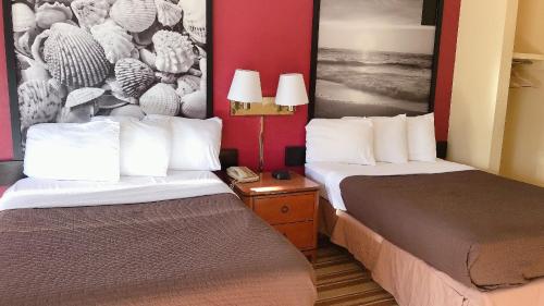 um quarto de hotel com duas camas e um telefone em Royal Palace Inn and Suites Myrtle Beach Ocean Blvd em Myrtle Beach
