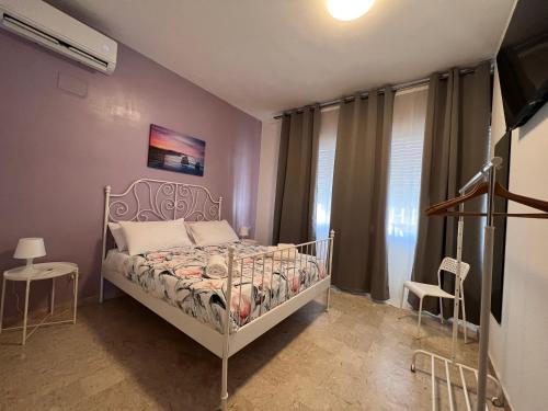 a small bedroom with a bed and a tv at Comeacasatua 2.0 in Bari