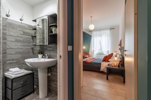 a bathroom with a sink and a bed in a room at [Confortevole Bilocale] in zona Porta Nuova in Turin